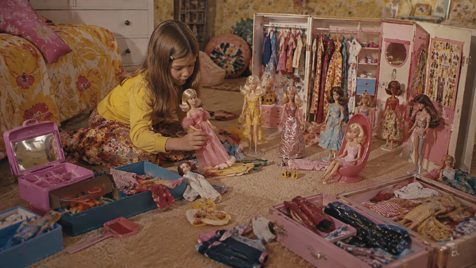 A child creating a sprawling Barbie fashion world with dolls, clothes, and accessories in a 1970s bedroom