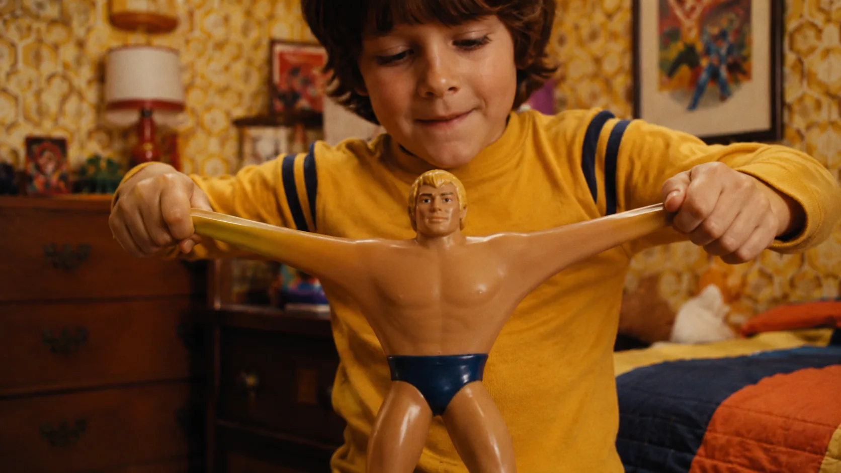 A child stretching the long elastic arms of a muscular 1970s action figure