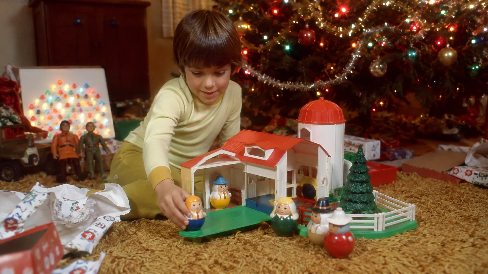 Child playing with Weebles and a playset on Christmas morning in 1971