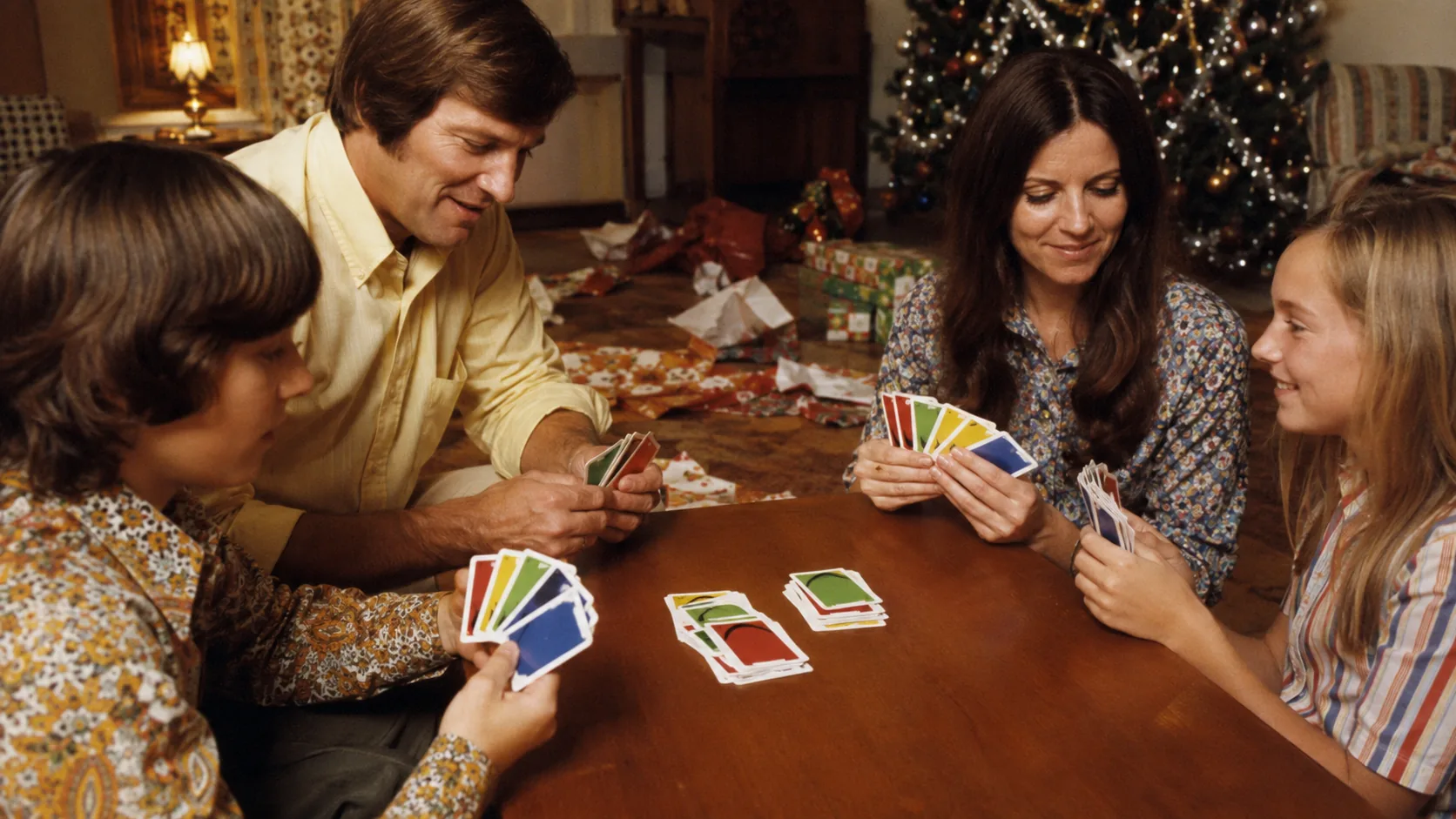 Family playing UNO together during Christmas in 1972