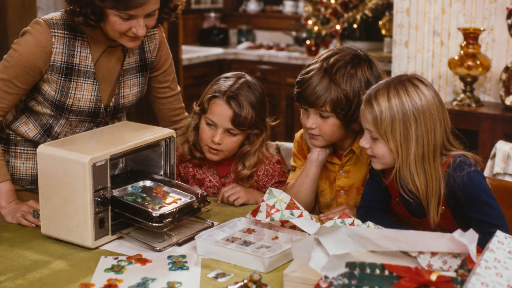 Children watching Shrinky Dinks in a small oven during Christmas 1973