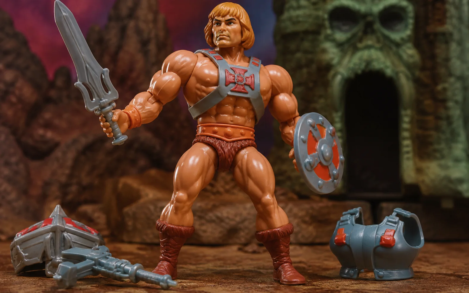 Close-up of a chunky muscular 1980s fantasy hero action figure with sword, shield, armor, and twisting-waist design.