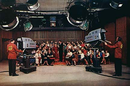 Happy Days cast performing on the diner set before a live studio audience