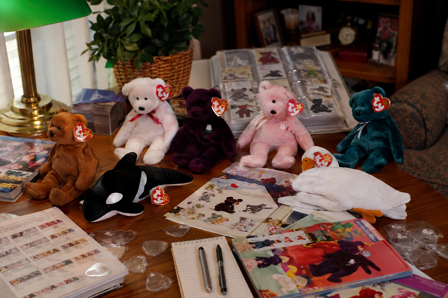 Beanie Babies collector workspace with price guides, magazines, checklists and protected plush animals