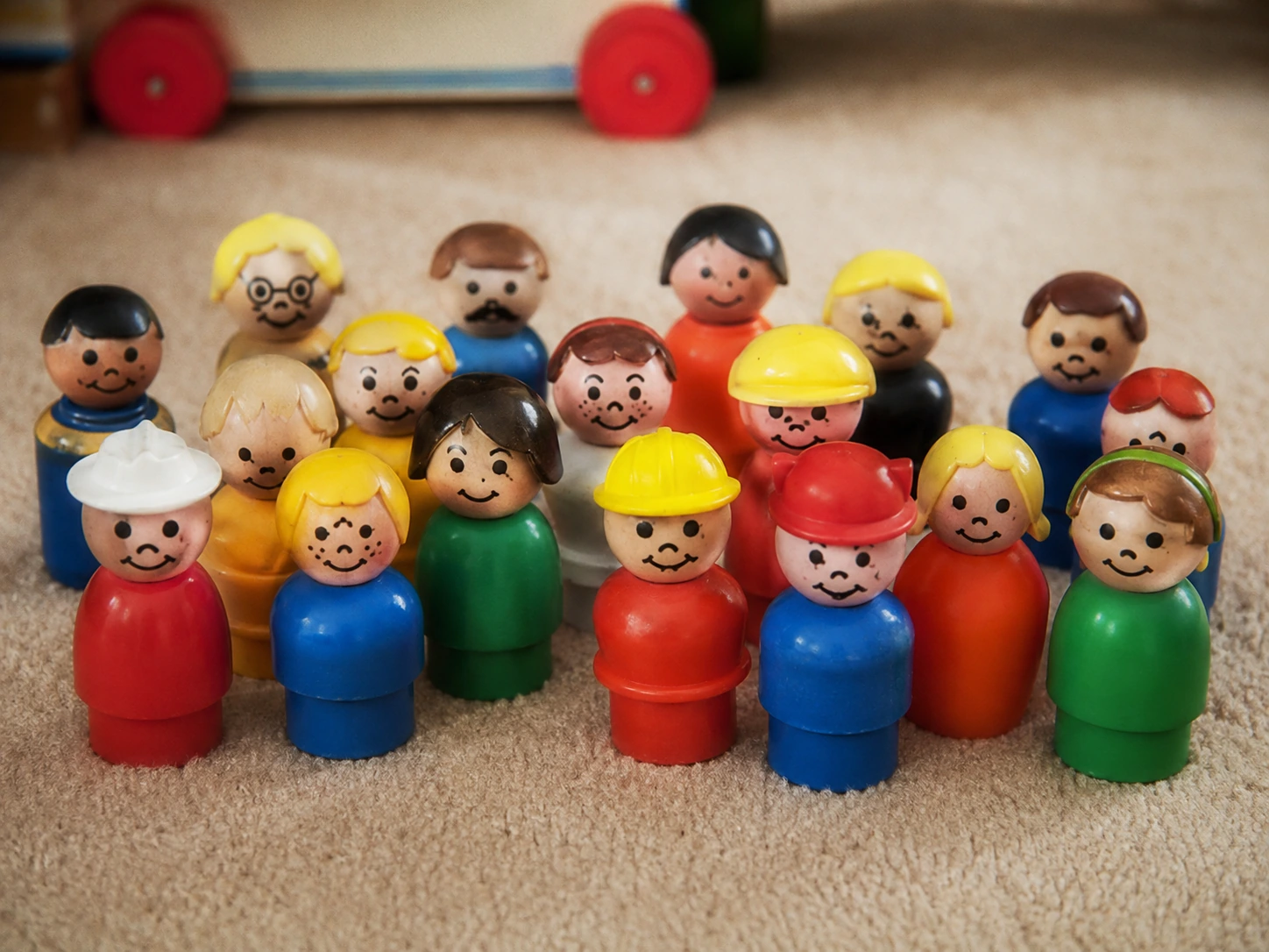 Group of vintage-style wooden and plastic peg-shaped Little People figures