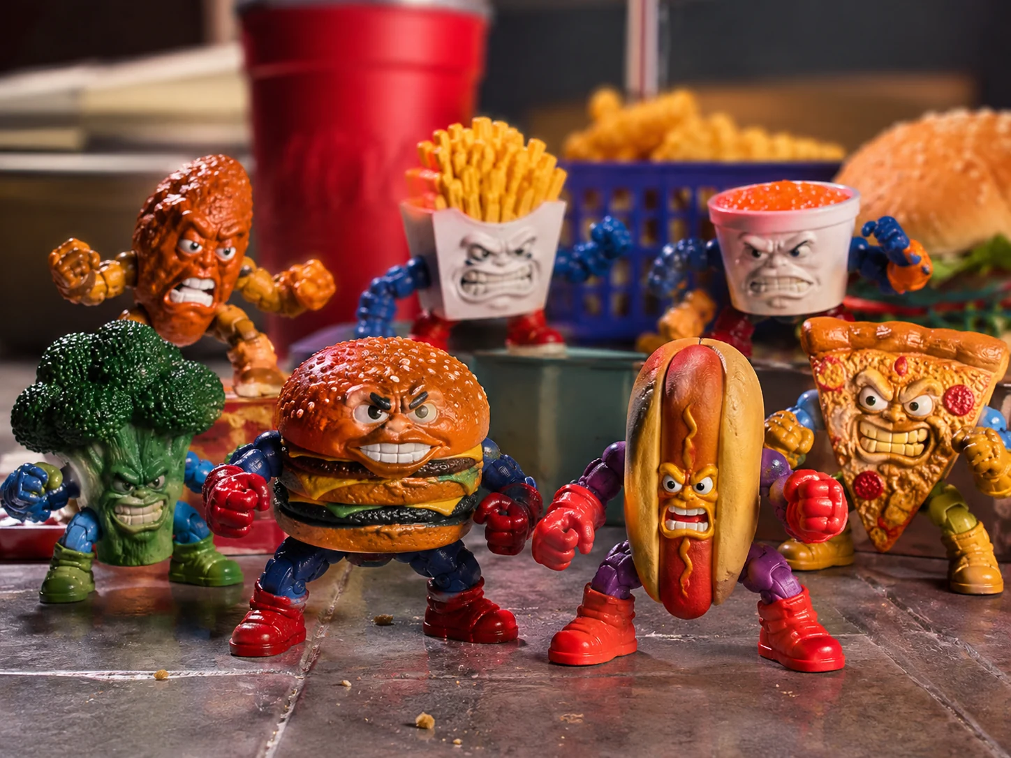 Anthropomorphic food-soldier figures battling across a glossy toy surface