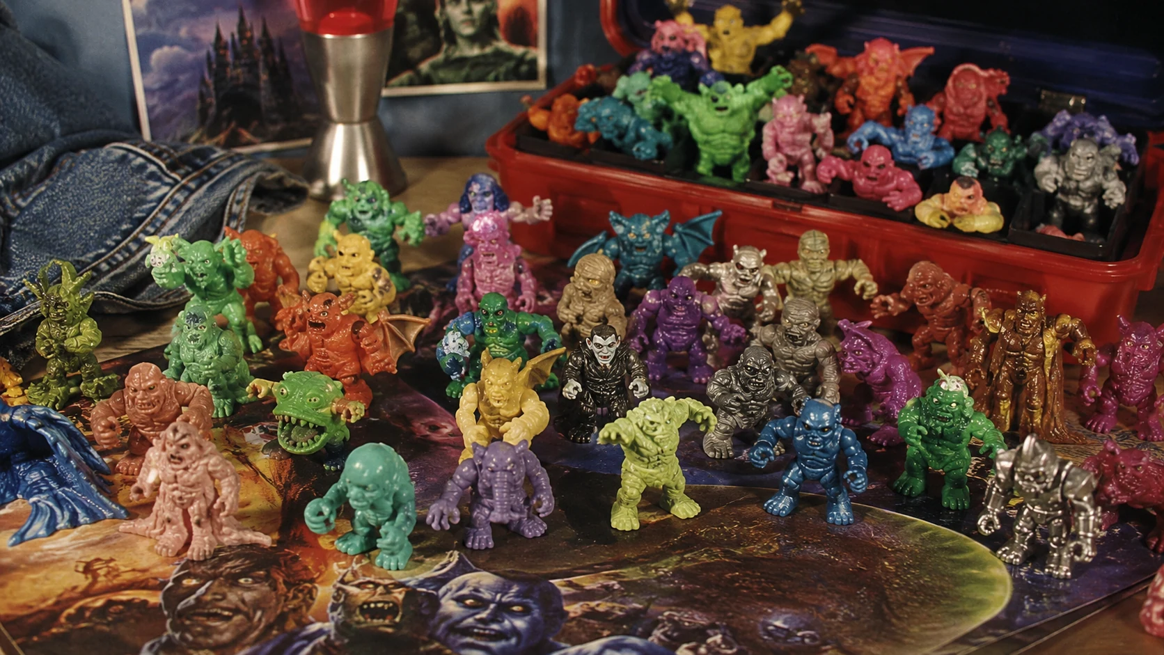 Colorful miniature monster figures arranged like a forgotten 1990s toy collection