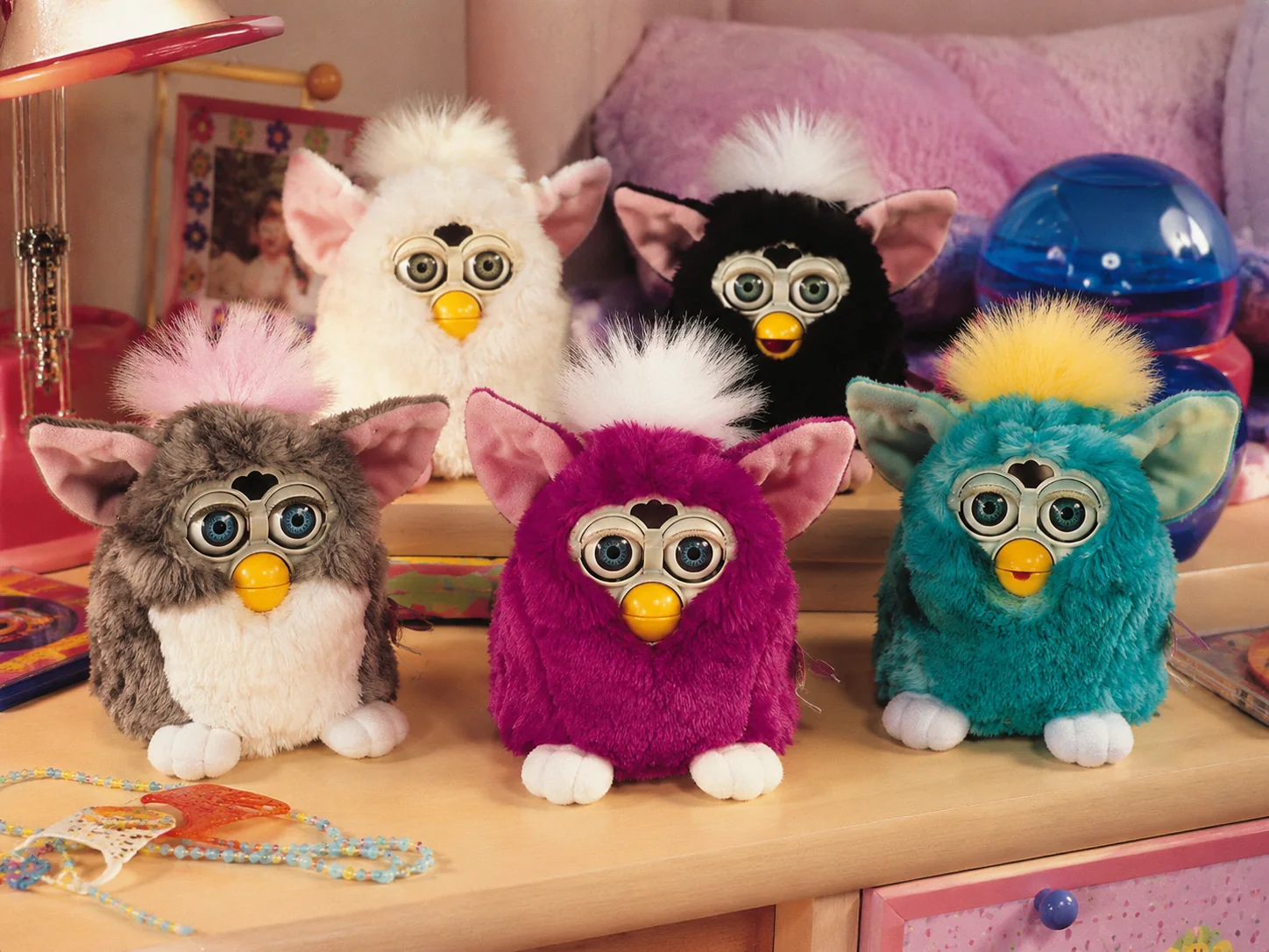 Colorful Furby toys displayed in a late 1990s bedroom
