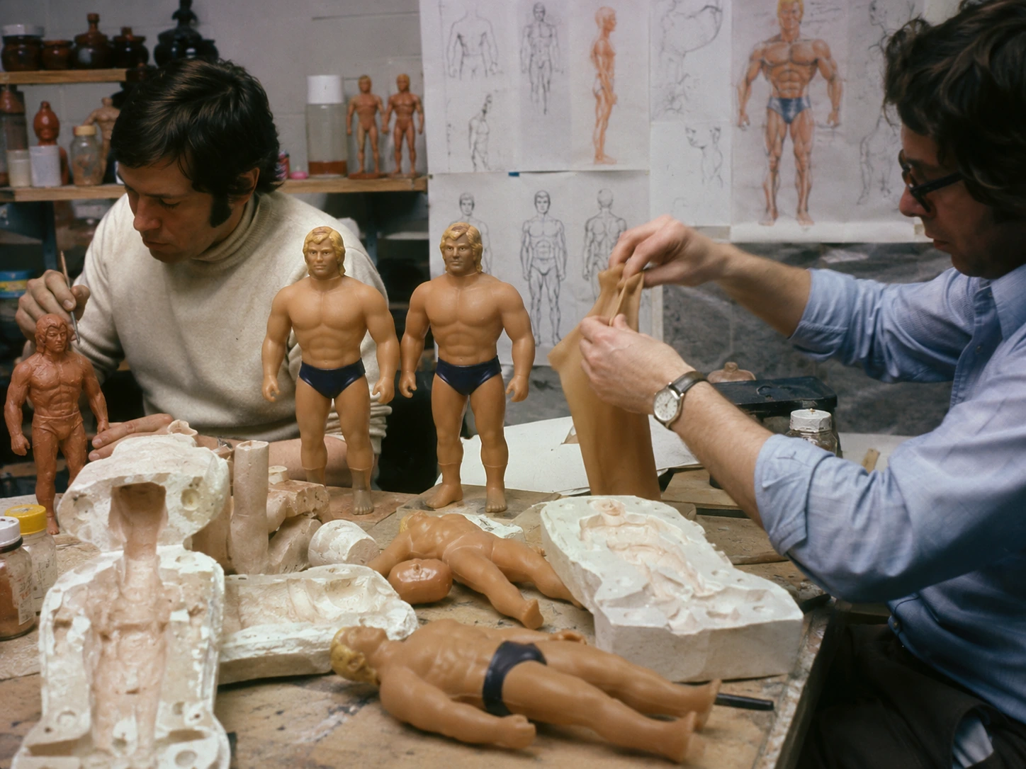 1970s toy designers developing Stretch Armstrong with molds, prototypes and flexible material samples
