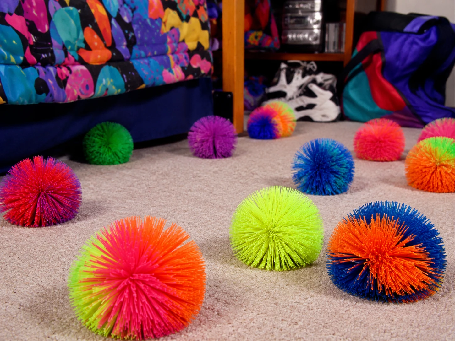 Colorful Koosh balls scattered across a bright 1990s bedroom floor