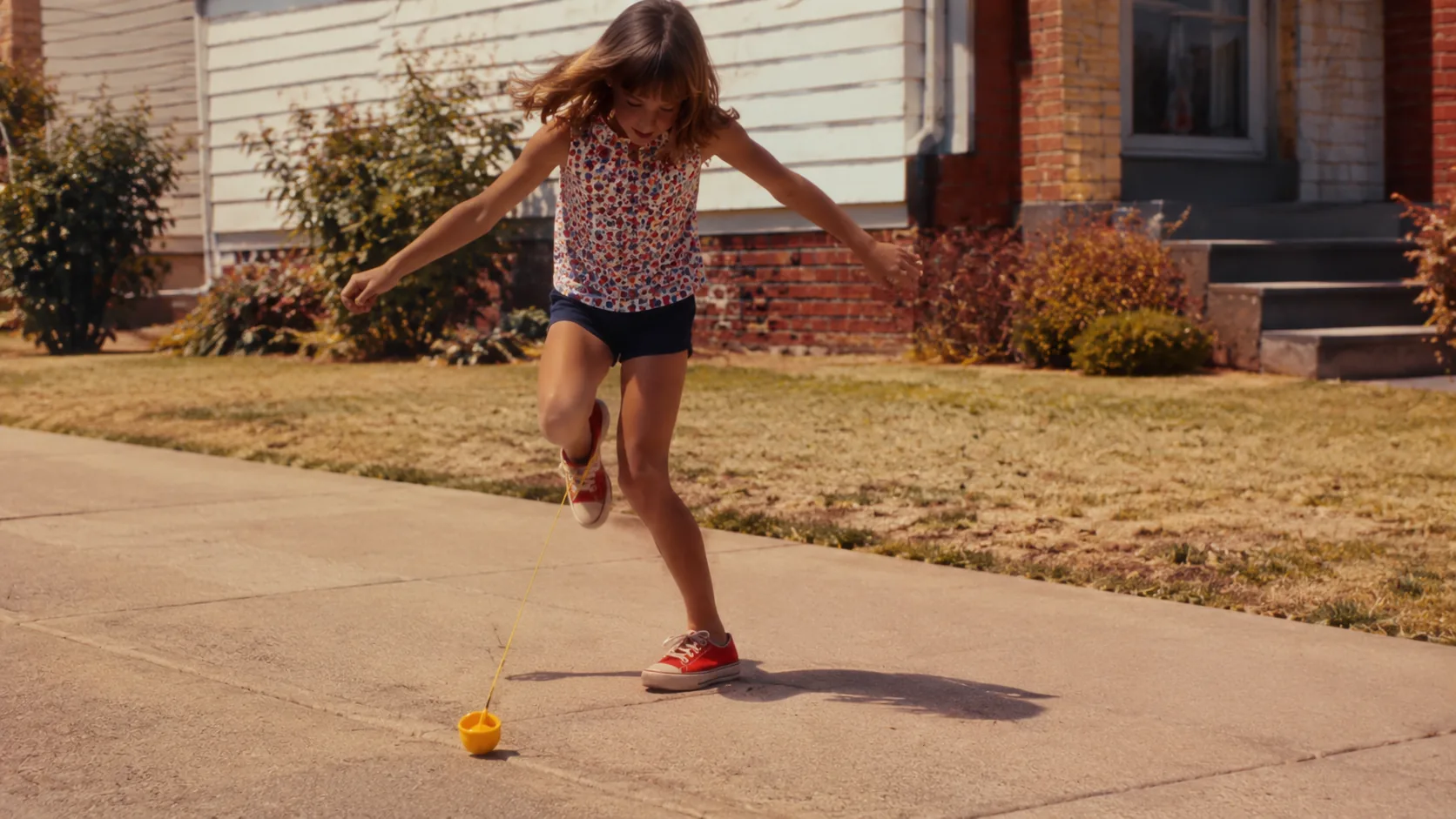 A child playing Lemon Twist on a sunny 1970s sidewalk