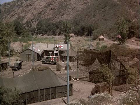 The M*A*S*H 4077th camp set with olive tents, jeeps and the familiar signpost