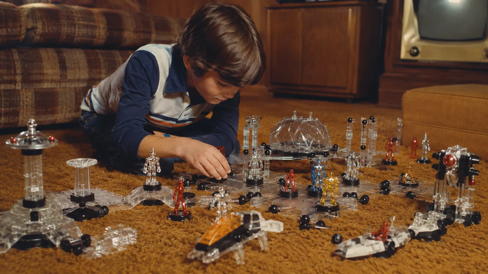 Children building a modular Micronauts space world with interchangeable figures, clear parts, magnets and vehicles