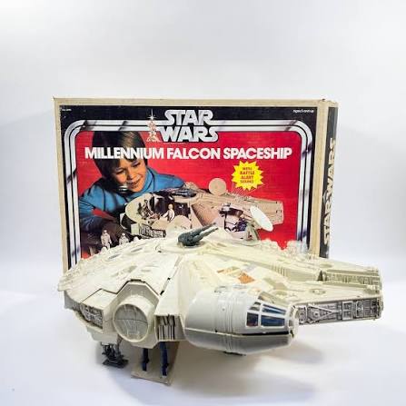 Open vintage Millennium Falcon toy showing its cockpit and interior play areas