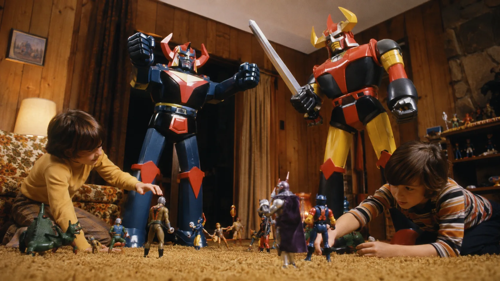Towering Shogun Warriors robot toys looming over smaller action figures during a living-room battle