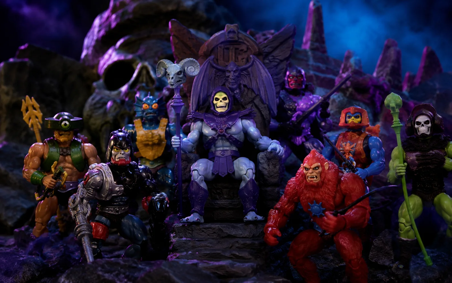 Skull-faced sorcerer and bizarre evil-warrior action figures posed in a dark fantasy fortress display.