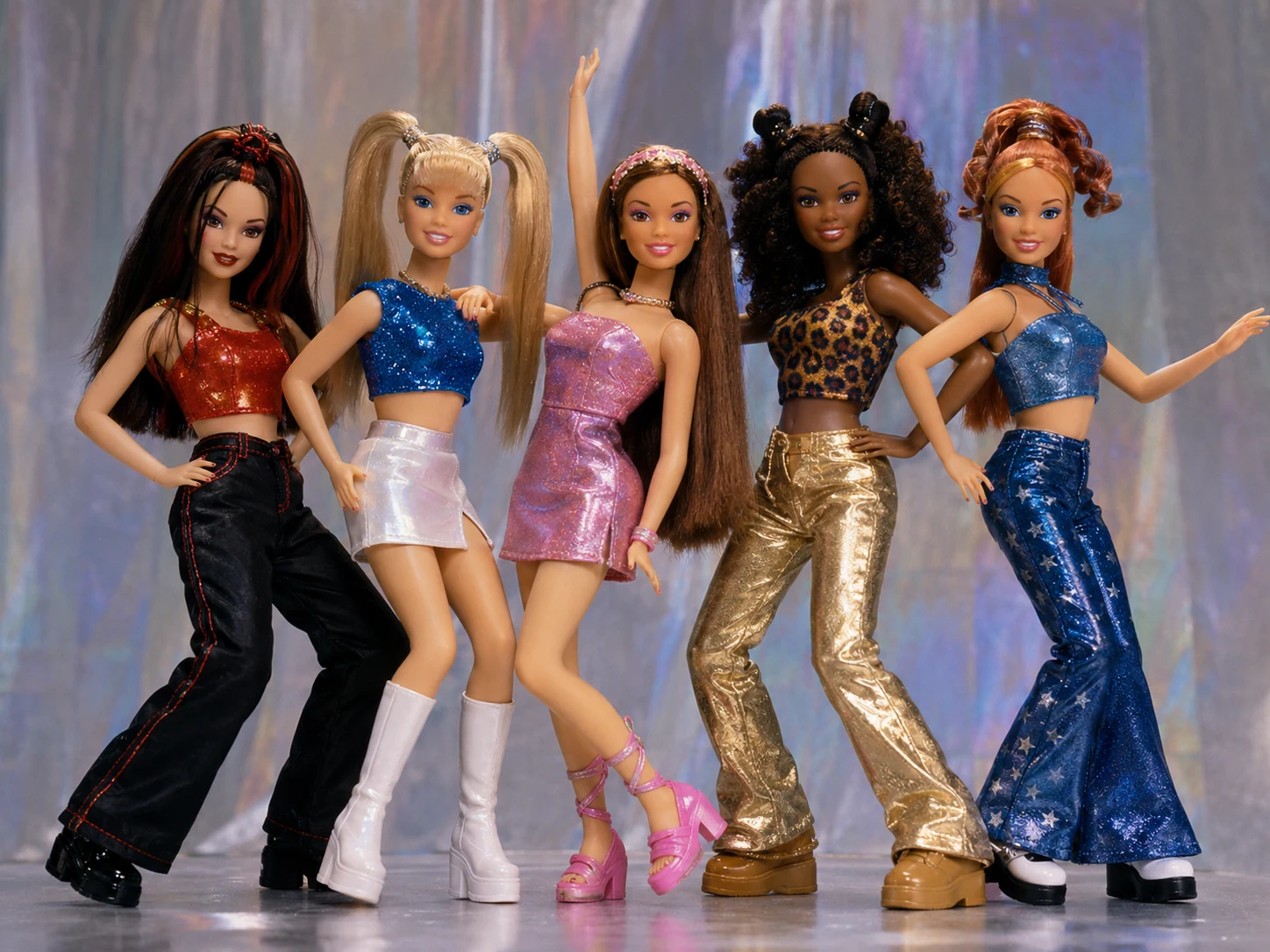 Five late-1990s pop-star fashion dolls posed together in metallic stage outfits
