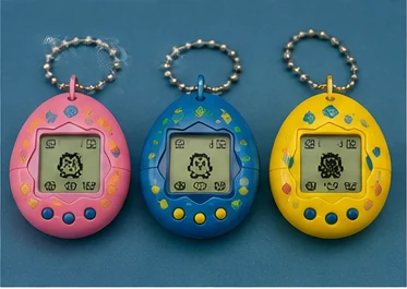 Colorful 1990s-style digital pet keychain toys arranged on a blue background