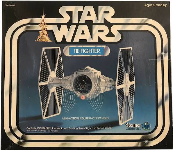 Vintage TIE-style starfighter toy with tall removable wing panels and pilot figure
