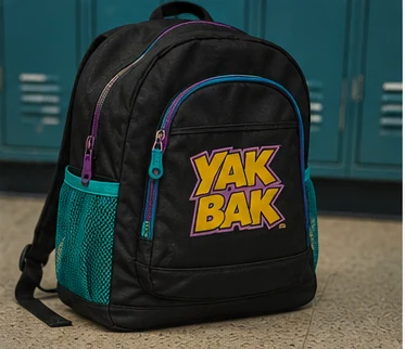 Black and teal 1990s backpack featuring a colorful Yak Bak-style design
