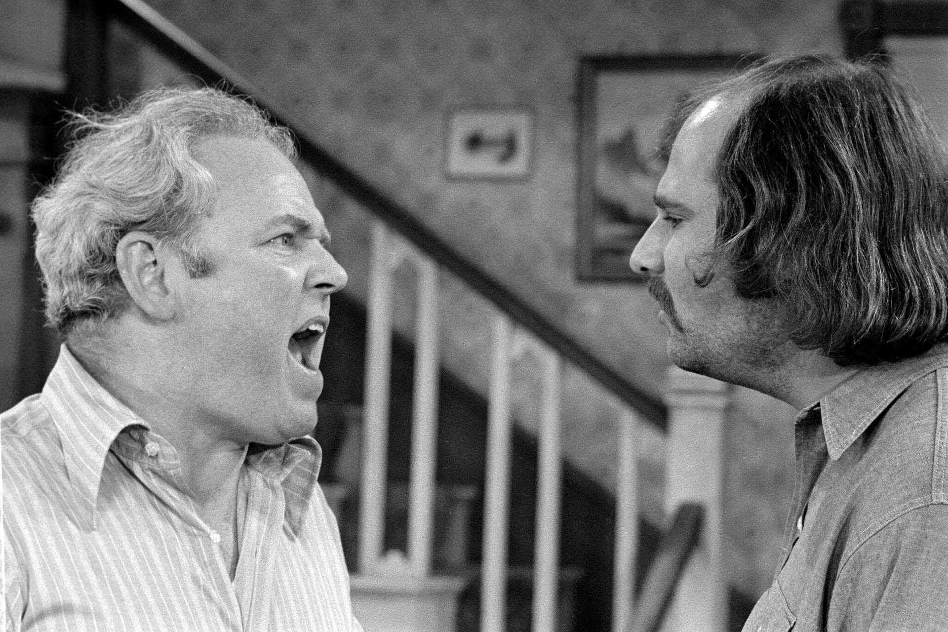 Archie Bunker and Mike Stivic arguing face-to-face