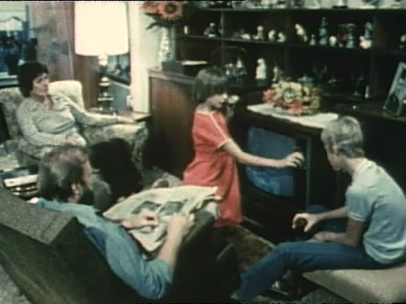 Children controlling the family television in a 1970s living room