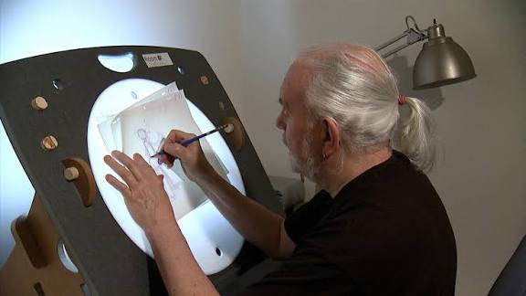 Animation artists working at light tables during 1970s cartoon production