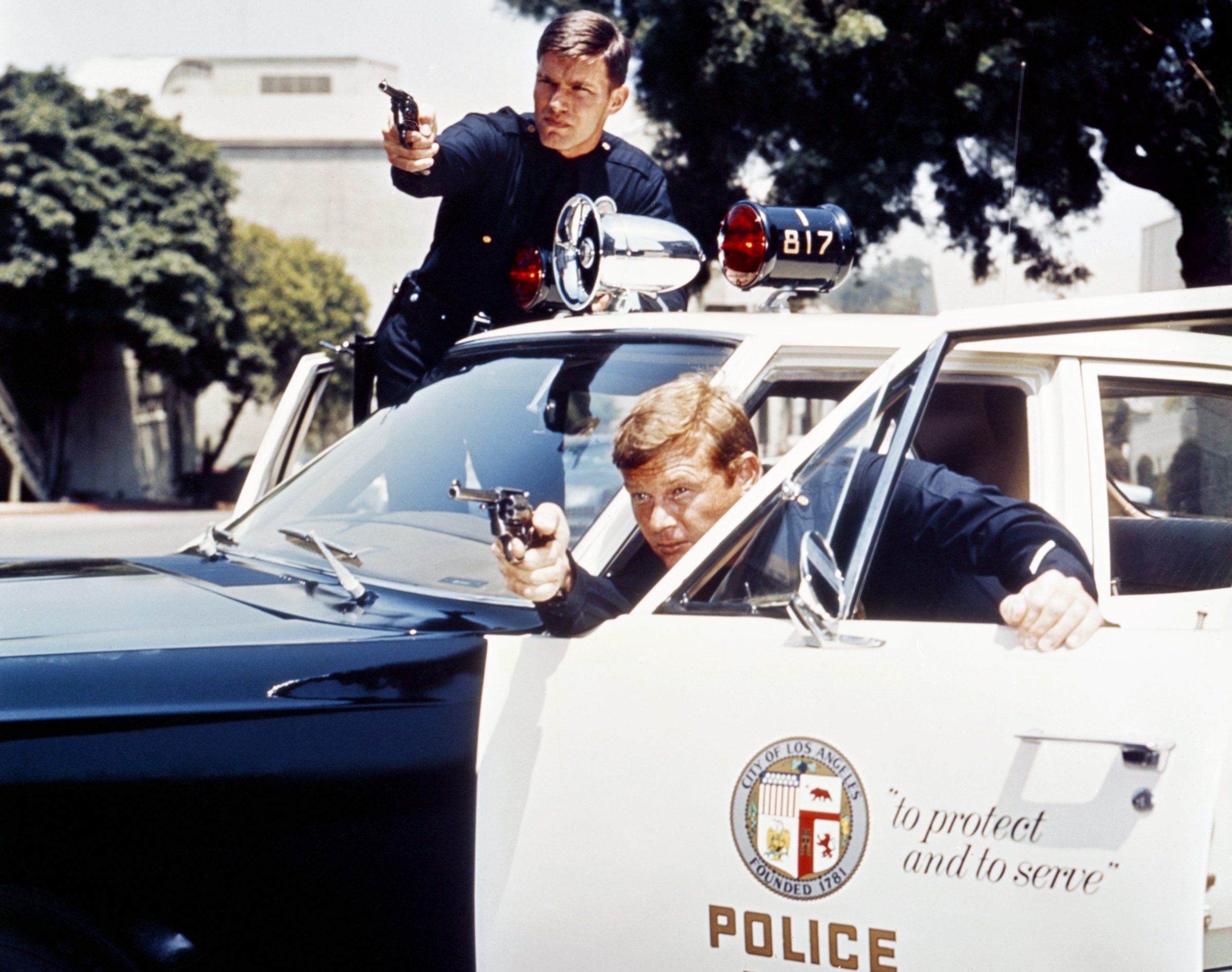 Pete Malloy and Jim Reed with their black and white patrol car in Adam-12