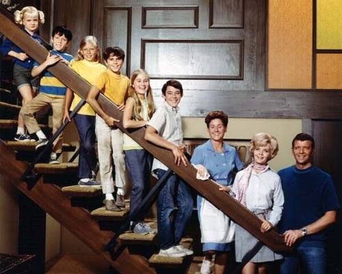 The Brady Bunch family gathered on the staircase