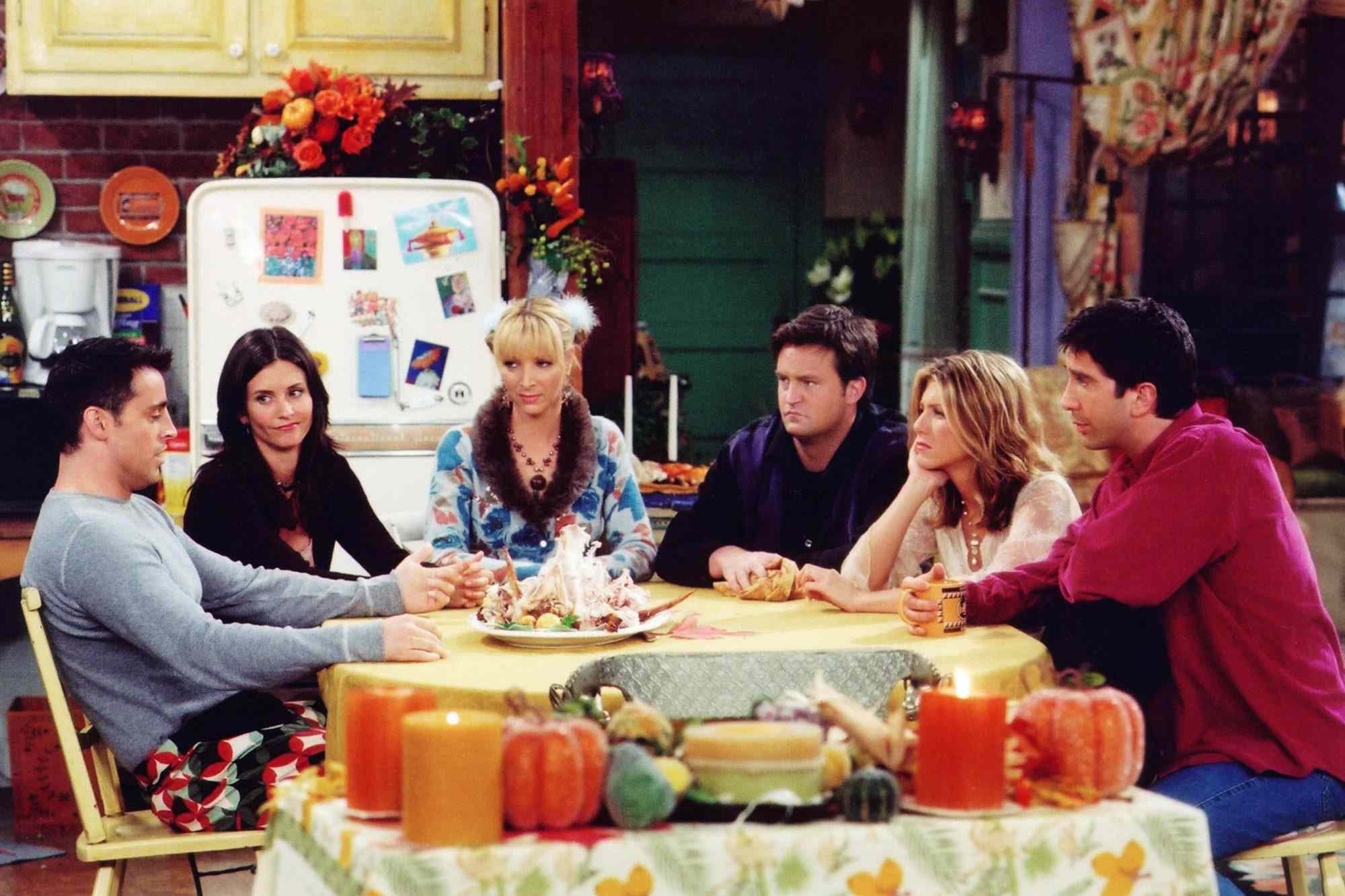 Friends cast together in Monica's apartment