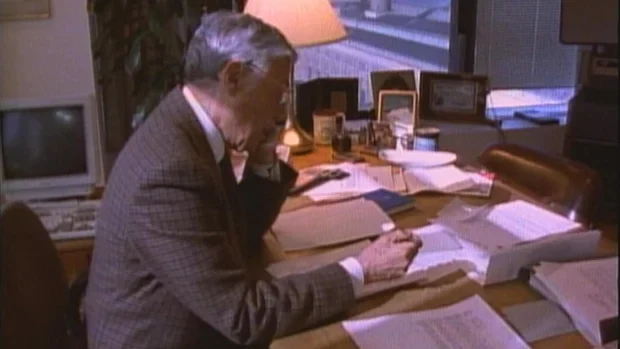 60 Minutes correspondent at a desk in the 1990s