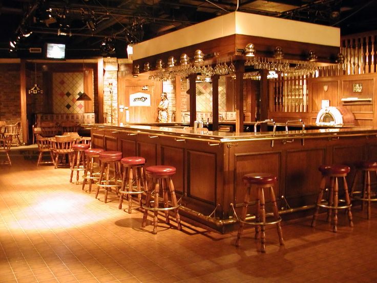 Cheers bar interior with stools, staircase and back bar